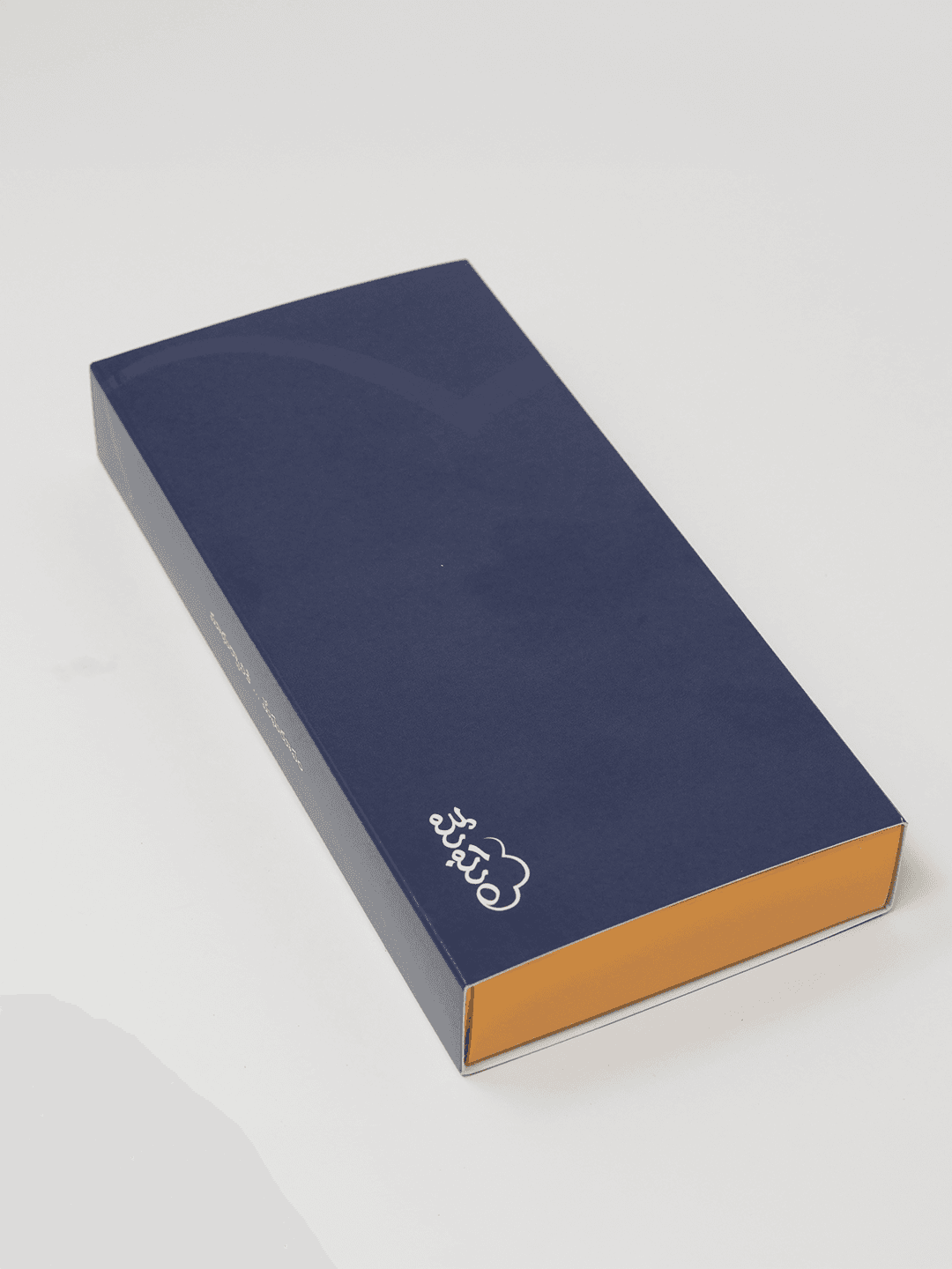 A long-format navy Megham chocolate gift box
