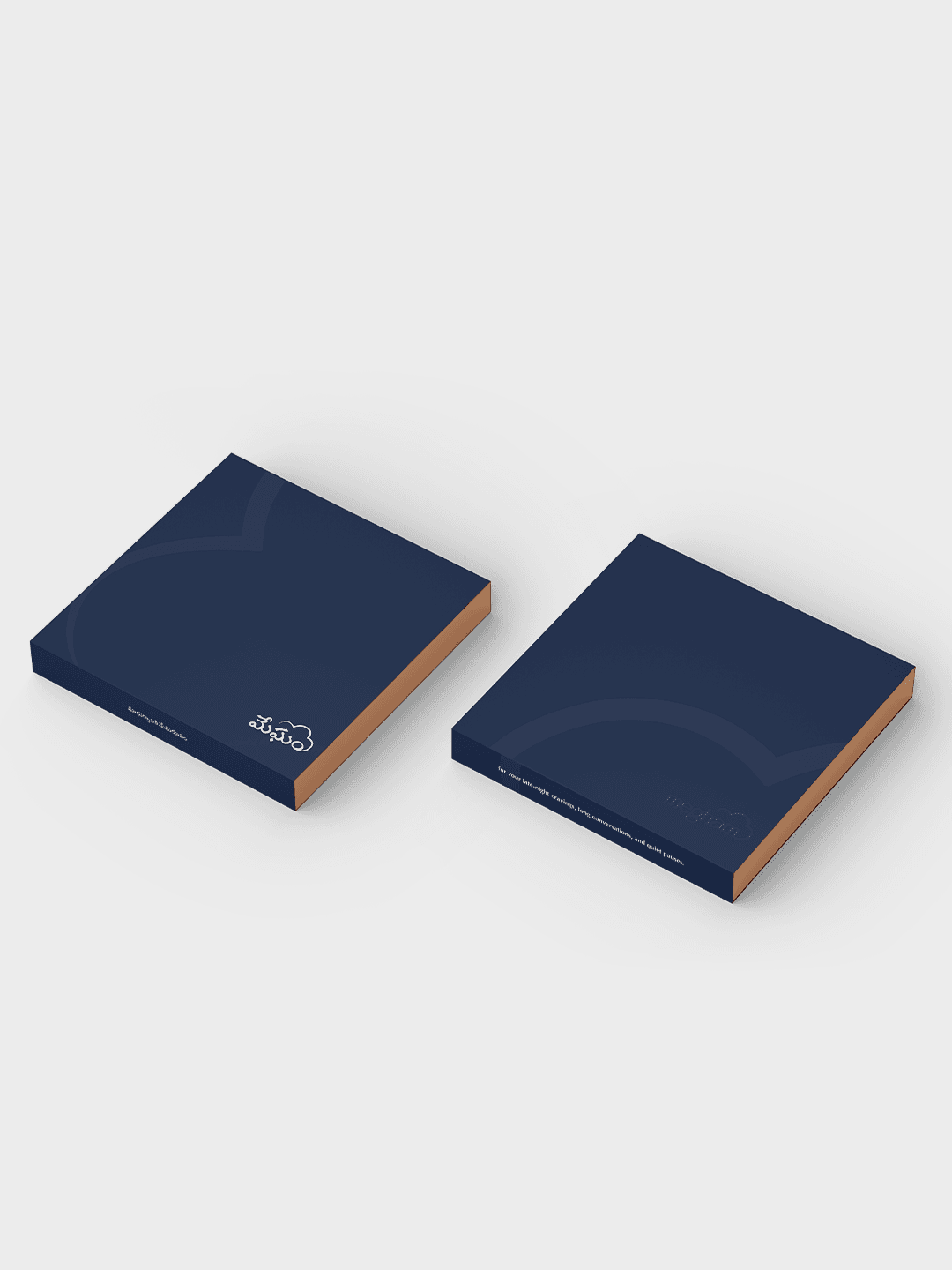 Two navy Megham chocolate gift boxes with copper edges